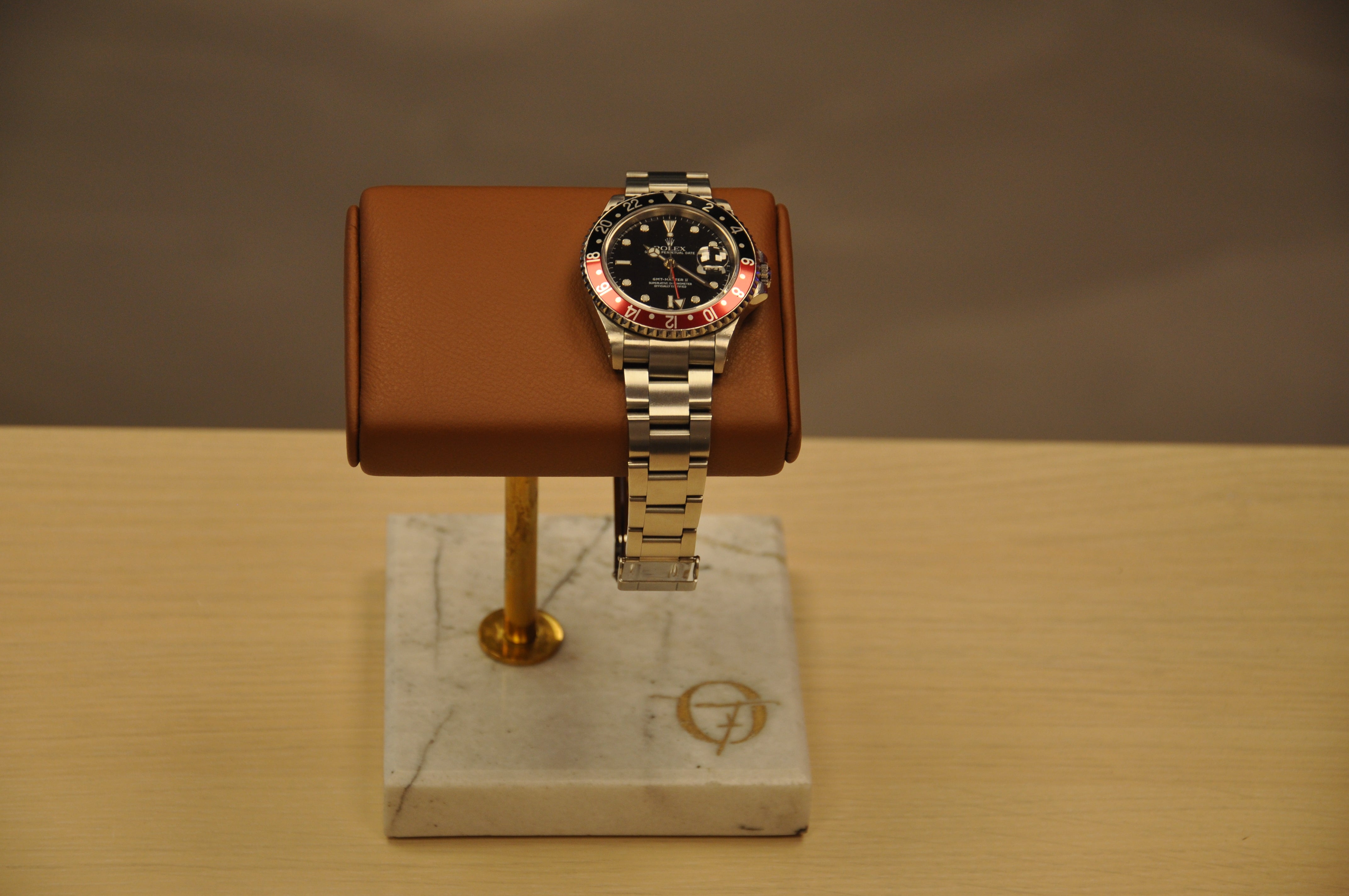 alt="Single watch stand displaying a luxury timepiece – OFL craftsmanship"
