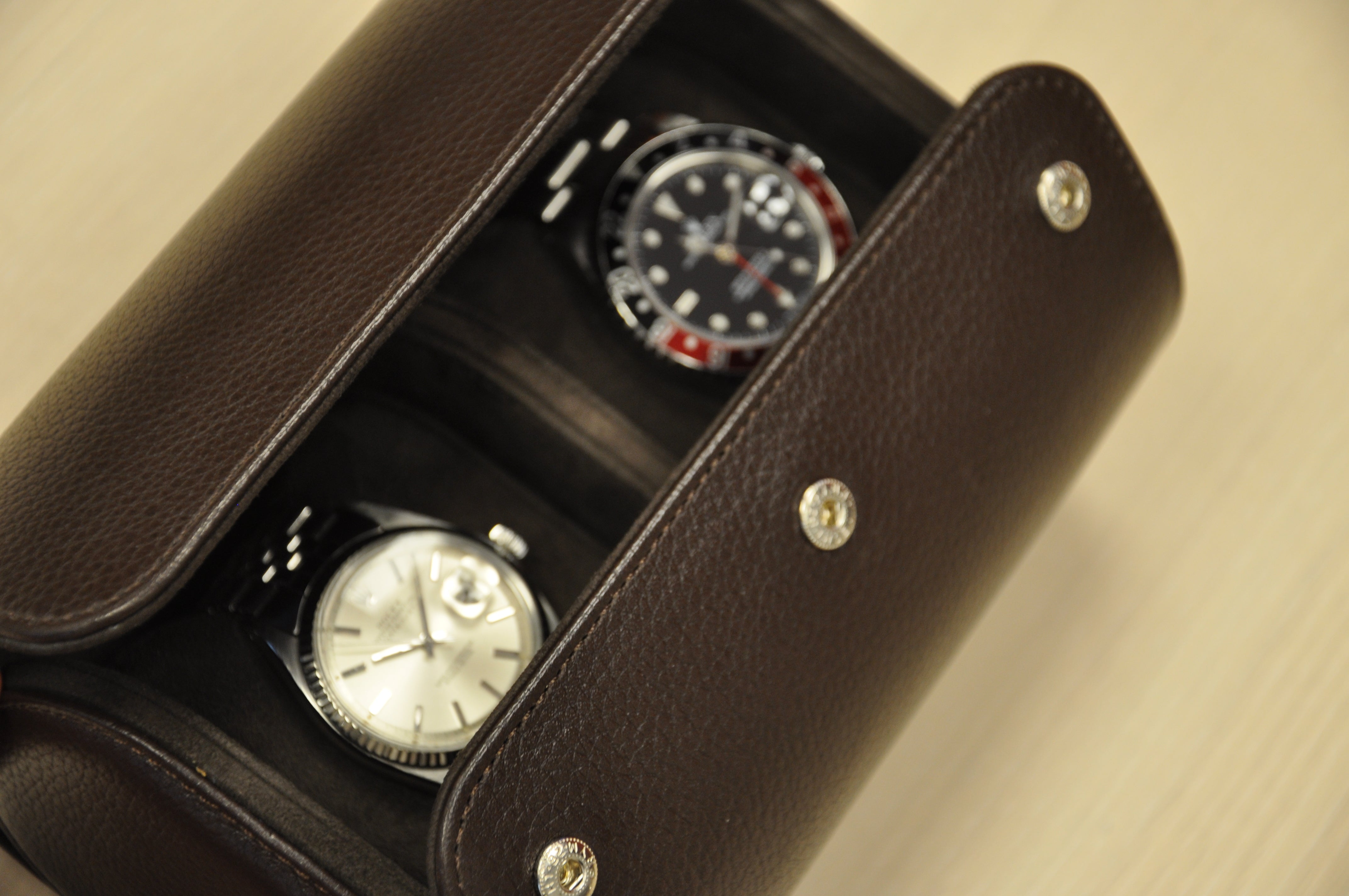 alt="Collection of premium leather watch rolls for multiple timepieces"