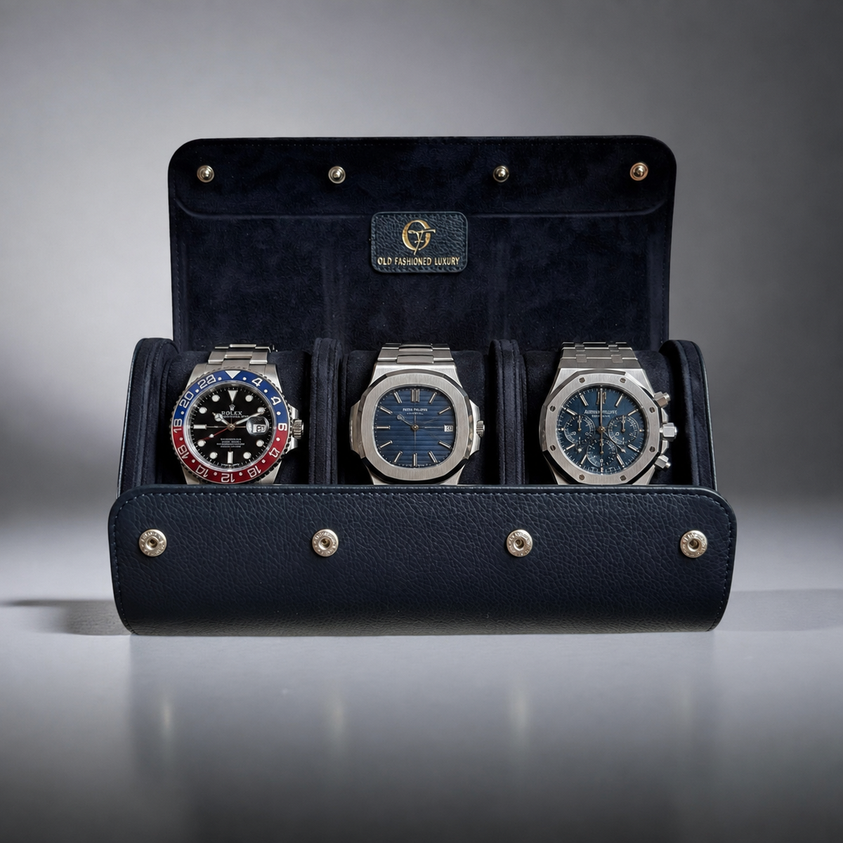 OFL handcrafted navy blue leather watch roll for three watches, open with three luxury watches inside