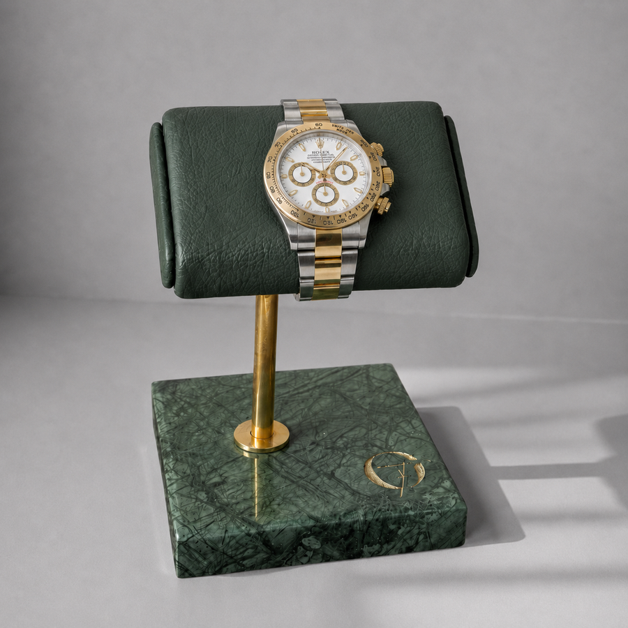 OFL green marble watch stand with emerald green leather cushion, holding a chronograph