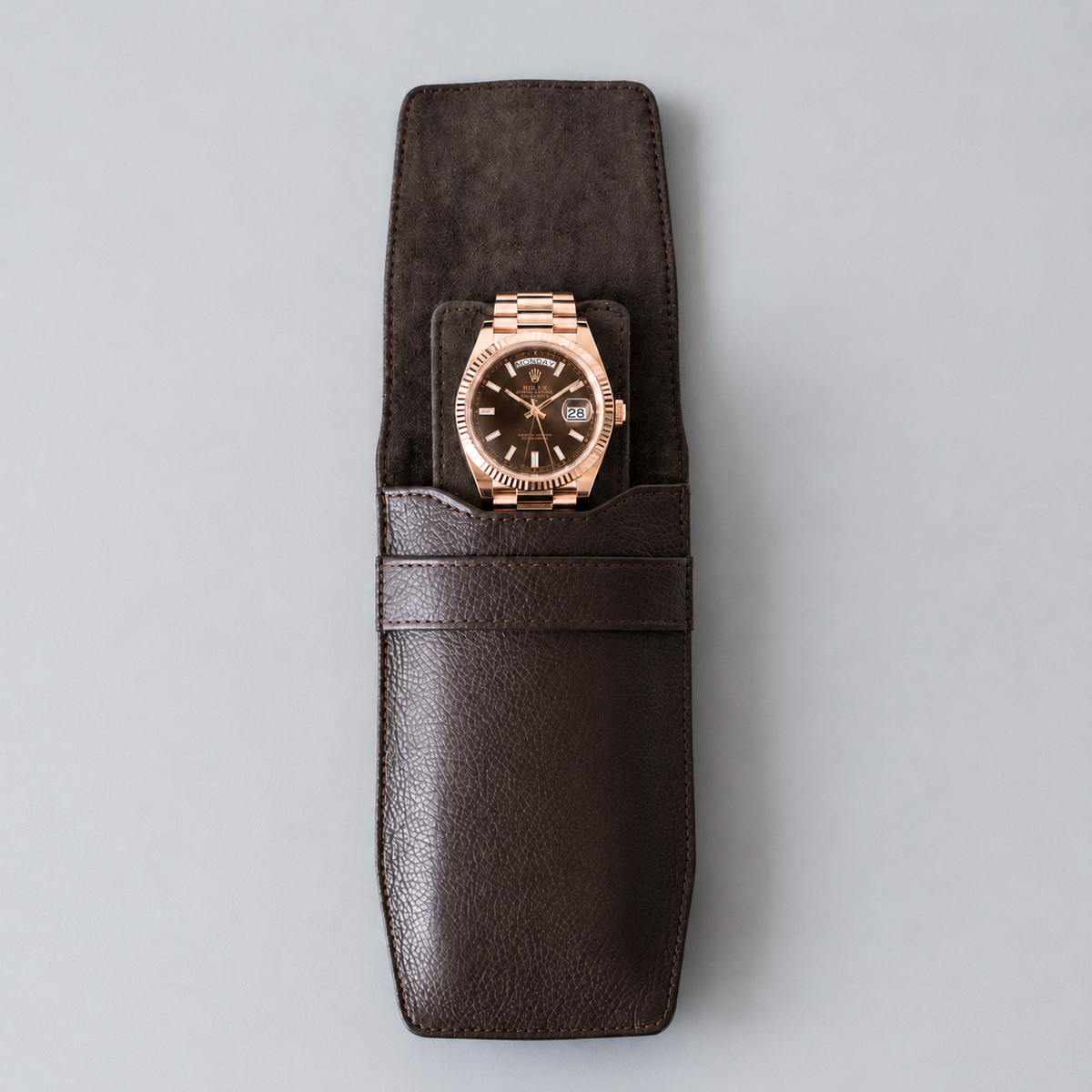 OFL handcrafted espresso brown leather watch pouch with a luxury watch inside, grey suede flap visible
