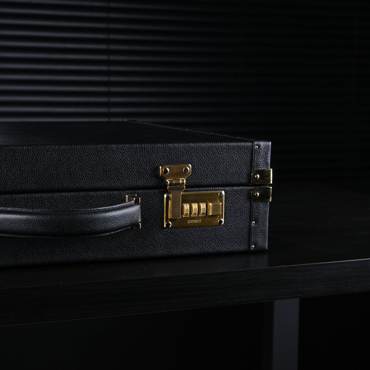 Close-up of the gold-plated Amiet combination locks on the OFL black leather watch case