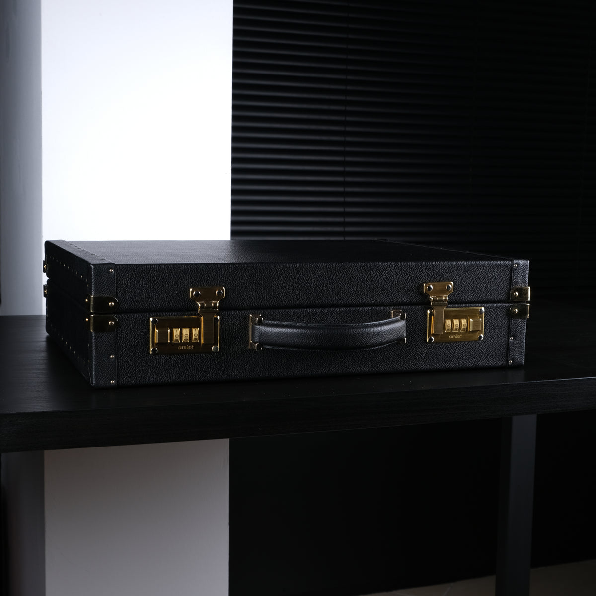 OFL black leather watch case, closed, side view with 24k gold-plated Amiet combination locks