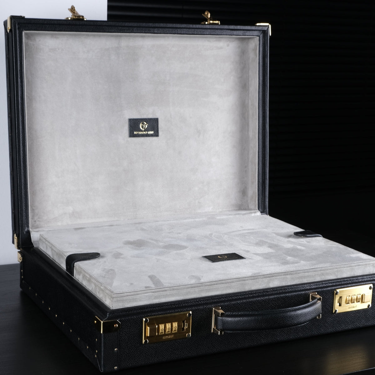 OFL black leather watch case for 10–15 watches, open, showing grey suede interior