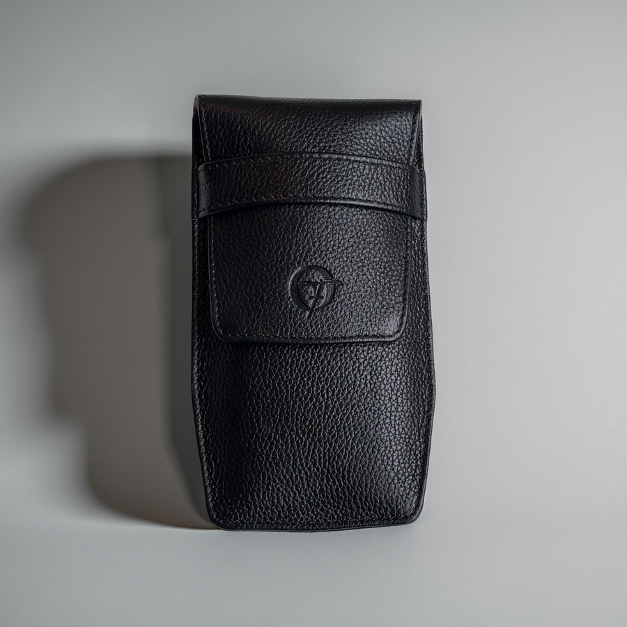 OFL handcrafted black full-grain leather watch pouch, closed, front view with embossed OFL logo