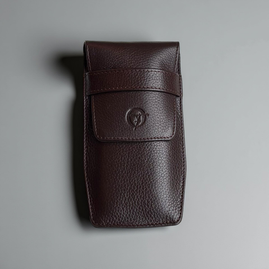 OFL handcrafted espresso brown leather watch pouch, closed, front view with embossed OFL logo